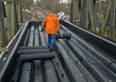 Rail bridge under maintenance with rolls of our structure protection mats to be laid.